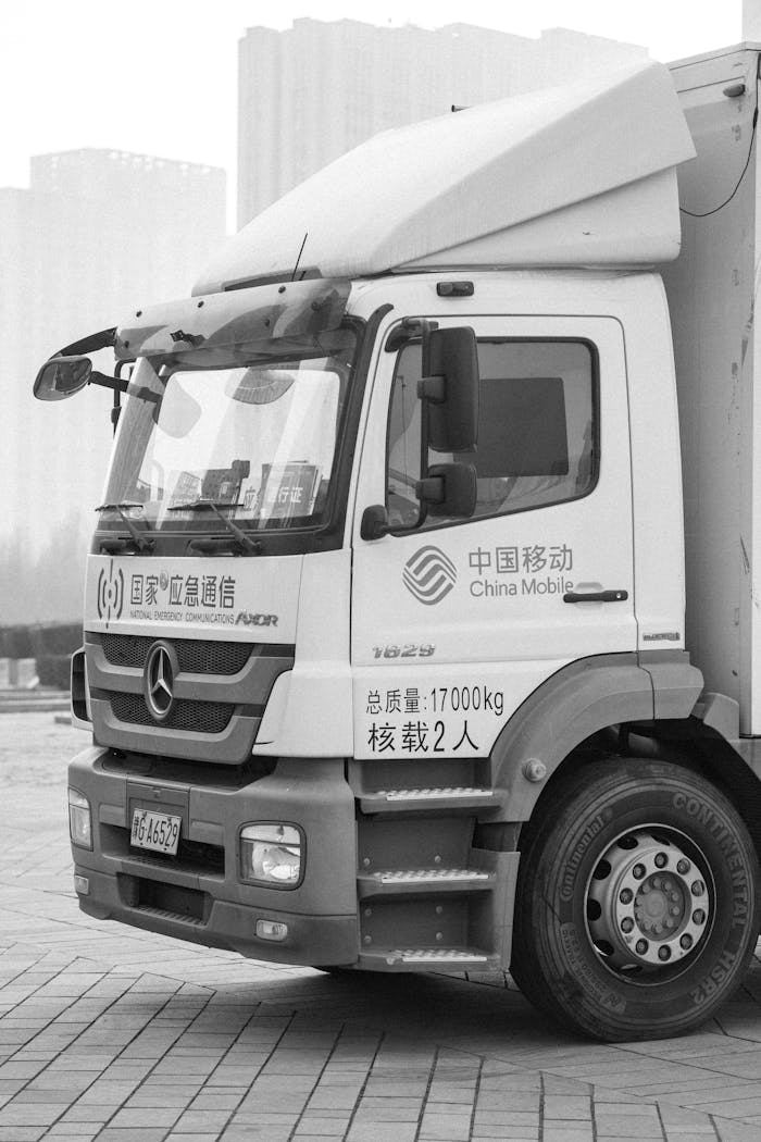Services Monochrome image of a logistics truck parked in an urban area, showcasing transportation essentials.